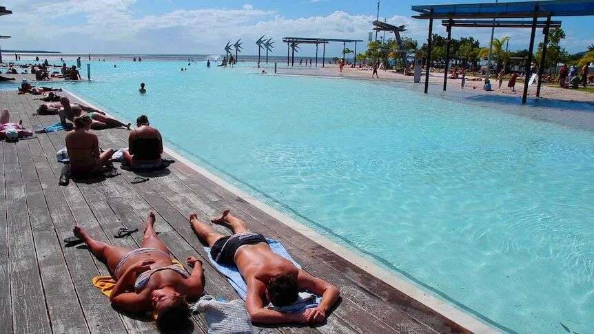 Tourists sunbaking at the Cairns Lagoon