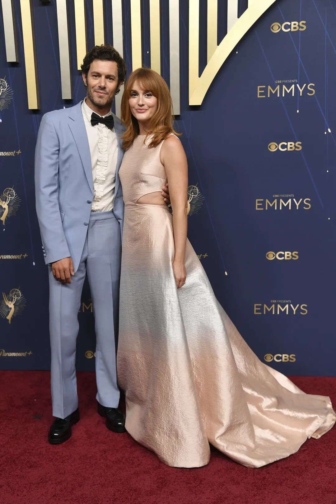 Adam Brody wearing a powder blue suit and Leighton Meester in a pale pink and blue dress