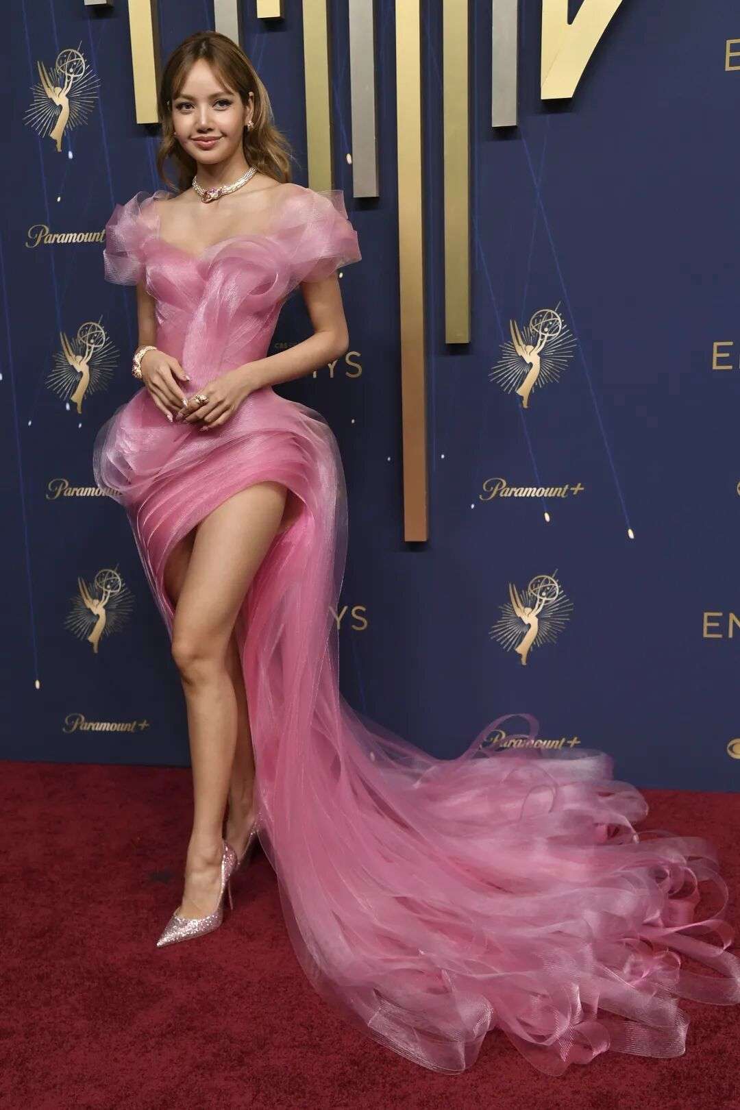 Lisa wearing a short off-the-shoulder dress our of bright pink fairy-floss-like fibres