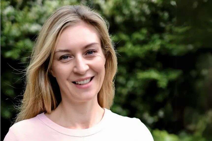 Woman smiles at camera - headshot