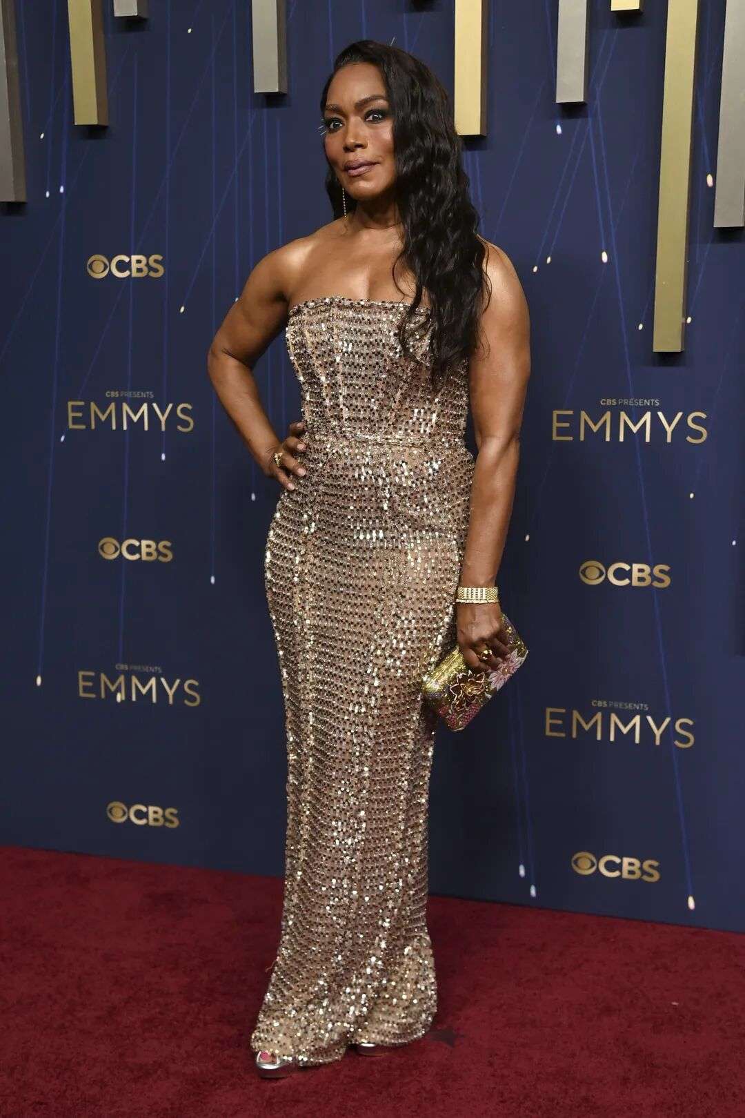 Angela Bassett wearing a gold embellished strapless dress
