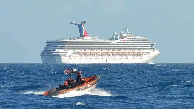 A small boat belonging to the Coast Guard Cutter Vigorous patrols near the Carnival Triumph in the Gulf of Mexico on Feb. 11, 2013. The Carnival Triumph floated aimlessly about 150 miles off the Yucatan Peninsula after a fire erupted in the aft engine room. (AP Photo/U.S. Coast Guard- Lt. Cmdr. Paul McConnell)