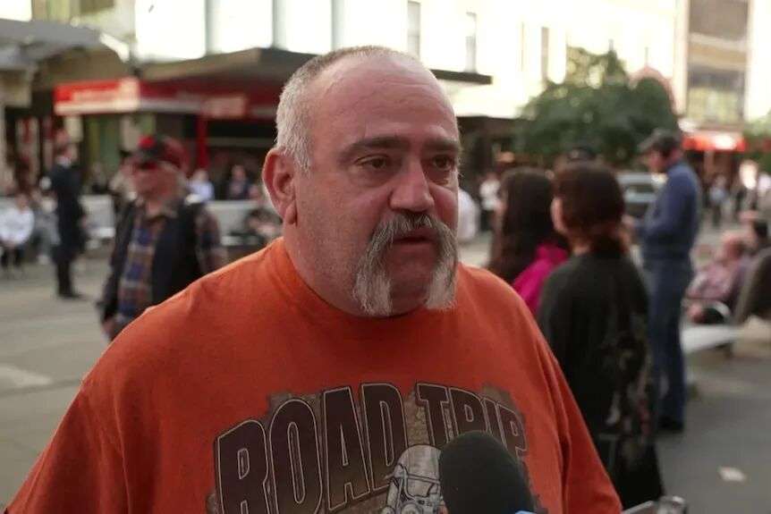 Middle aged man in orange t-shirt