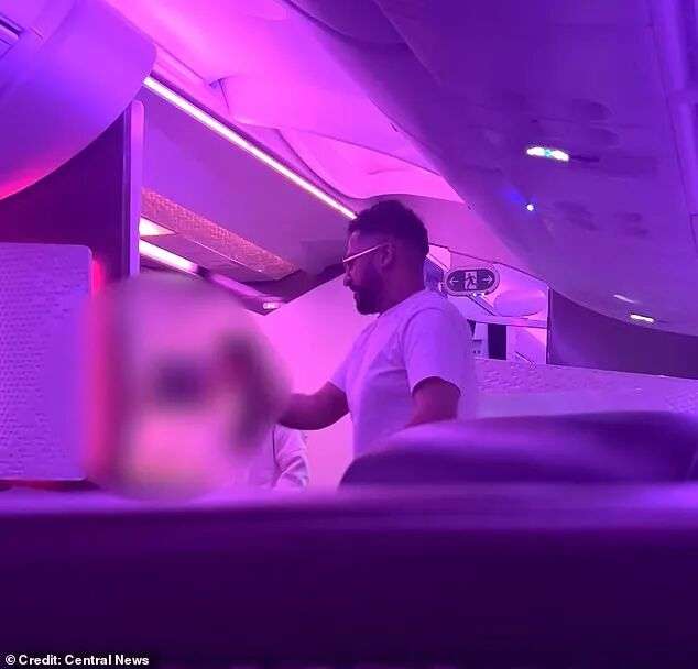 This is the moment Virgin Atlantic passenger Salman Iftikhar, 37, (centre) launched a vile tirade towards the cabin crew of his flight after being told to stop helping himself to ice from the bar