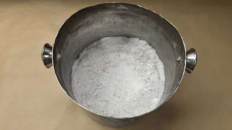 An x-ray revealed inconsistencies around the lining of a cooking pot that was in his suitcase.