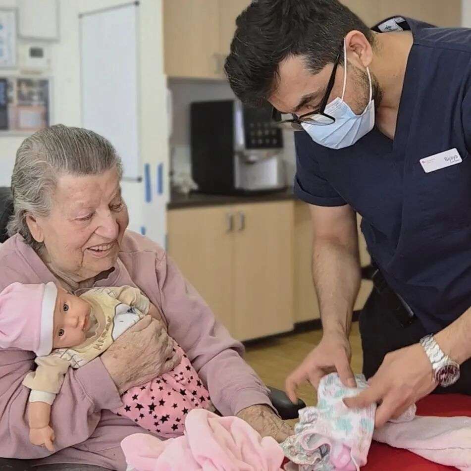 Elizabeth Ziogas with a St Basil's Lakemba aged care worker. Picture: Supplied