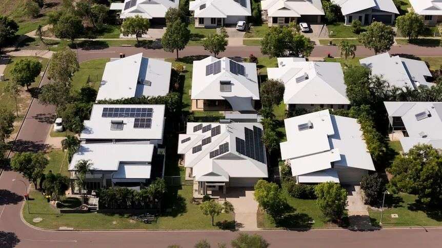 An aerial shot of white roofed houses.