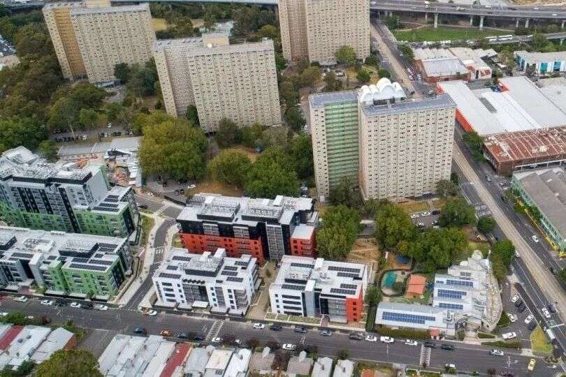 A drone image showing newbuild medium density apartments next to Melbourne's public housing towers