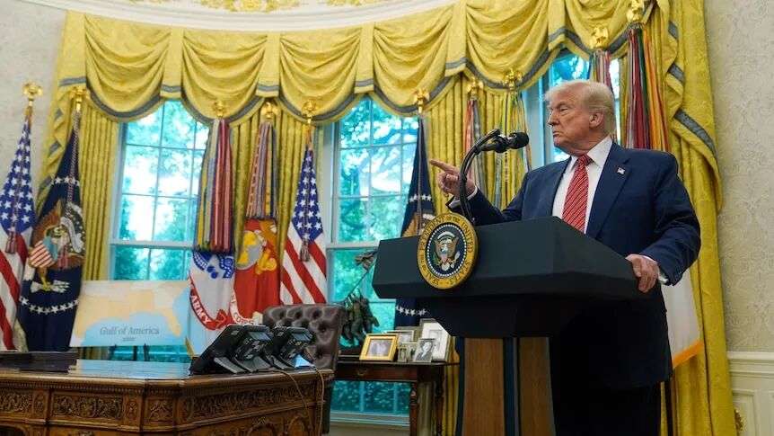 US President Donald Trump speaks to reporters from behind a lectern in the oval office
