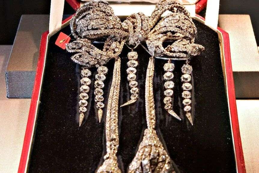 Close up of a diamond ribbon brooch in a velvet case