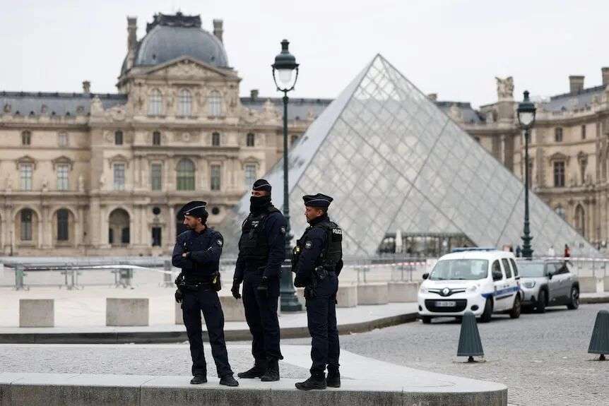 Three police officers outside the Louvre in Paris.