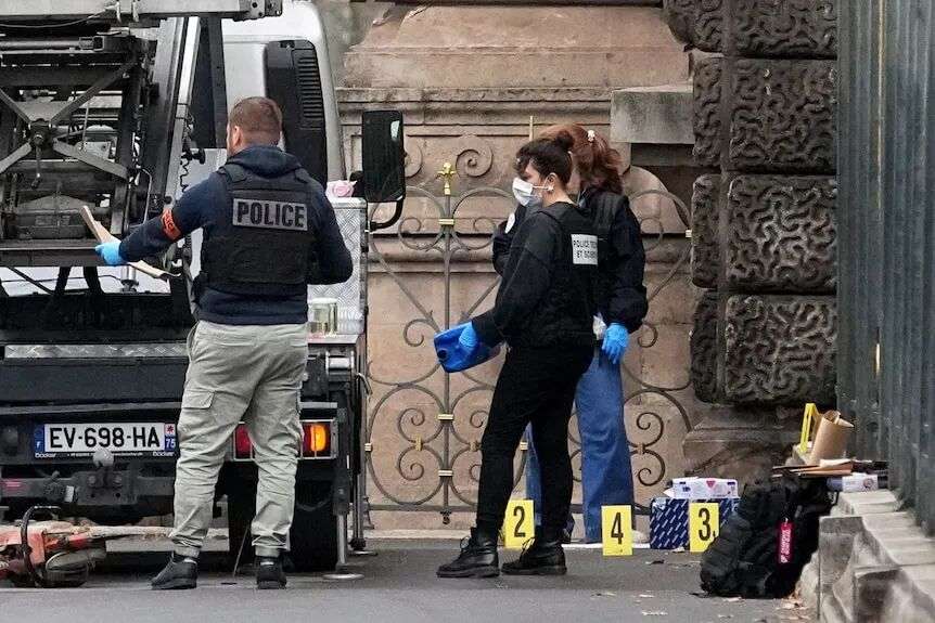 A large handheld power tool with orange and black casing appears to be laying on the ground