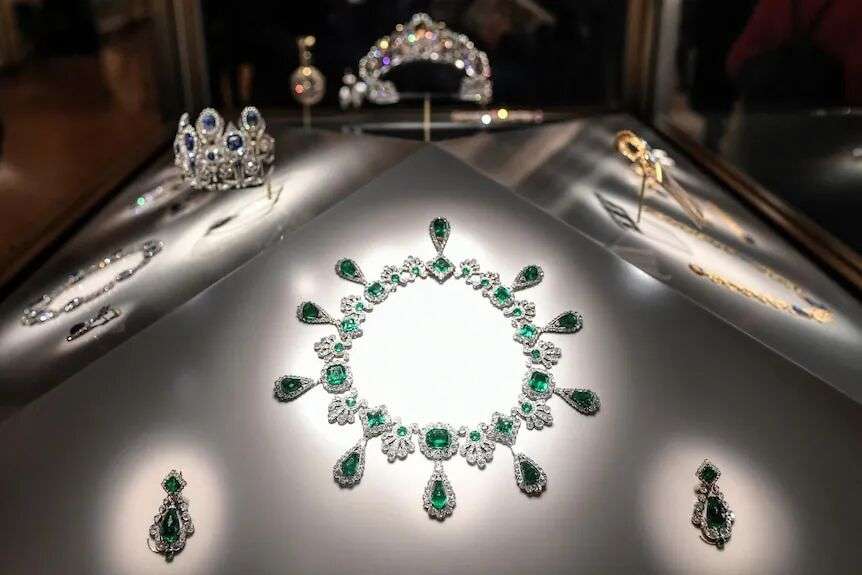 Emerald and diamond necklace at the centre surrounded by other jewels.
