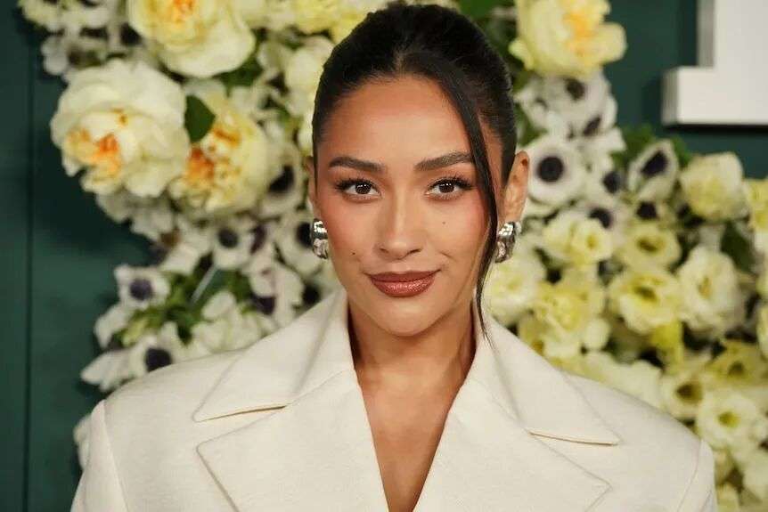 A close up of actress Shay Mitchell posing on the red carpet at an event