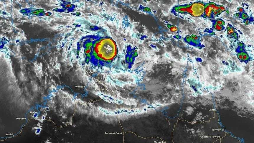 An infrared satellite view over the NT coast which shows a colourful swirl over the land.