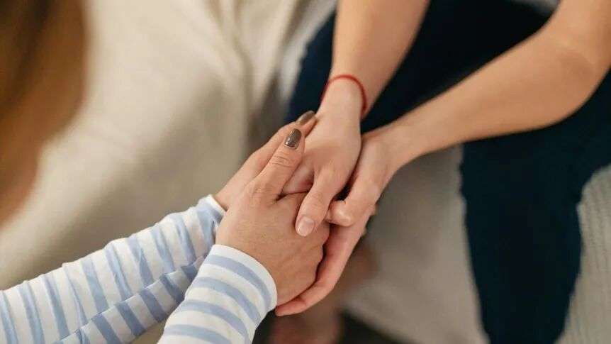 close up of two women holding hands