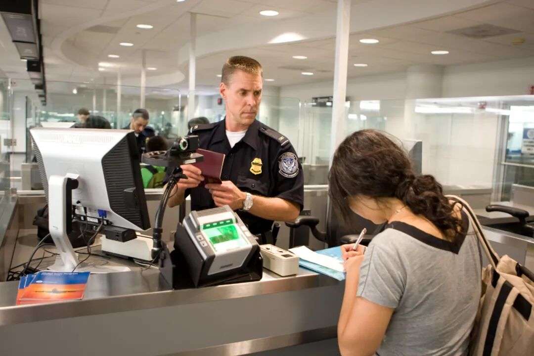 U.S. Customs and Border Protection (CBP) agent processes a passenger into  the U.S. at an airport | Homeland Security