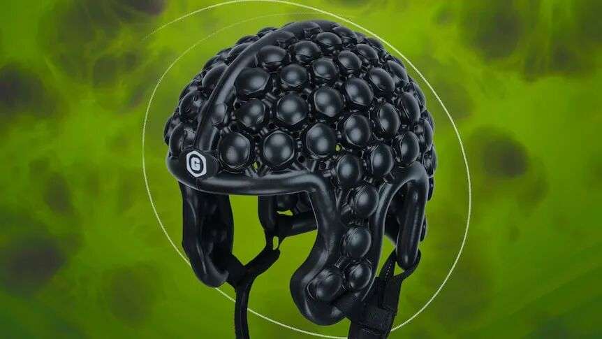 A black helmet with a bubble-like exterior against a green backdrop.