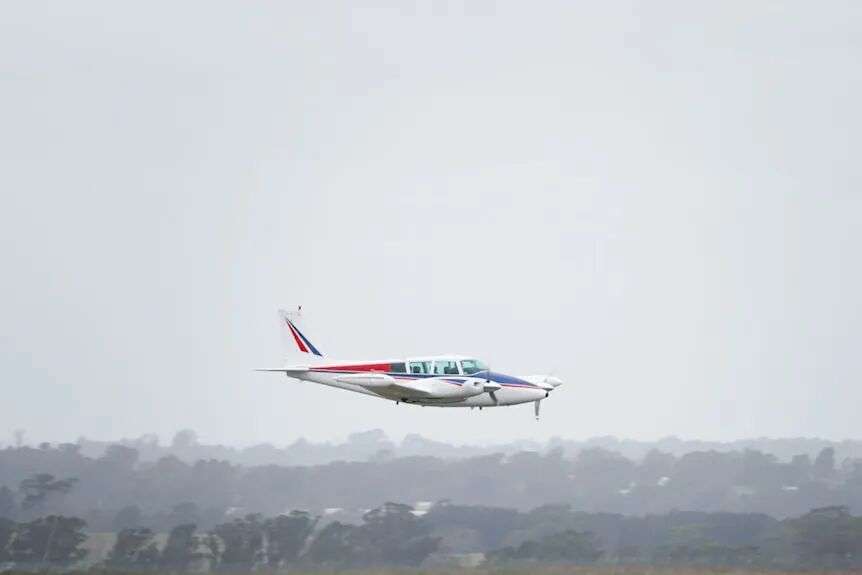 Plane in sky lands on tarmac