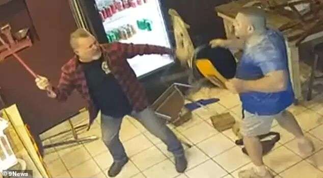 Lance (in blue) wields a chair against another man armed with a crowbar