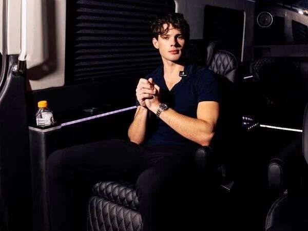 Braden Peters sitting in a black leather chair.