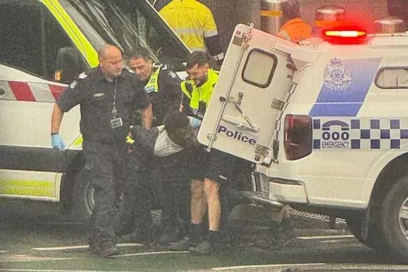 Police officers arrest Jerry Sowood on Wednesday.