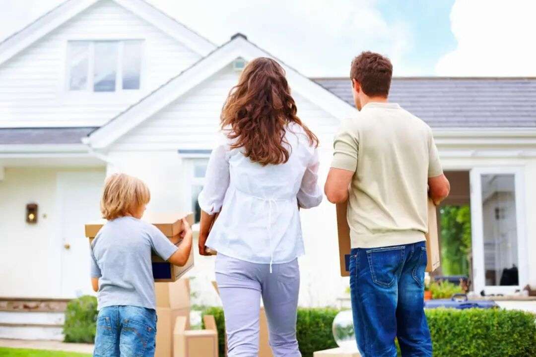 Middle aged couple with their son moving to new house